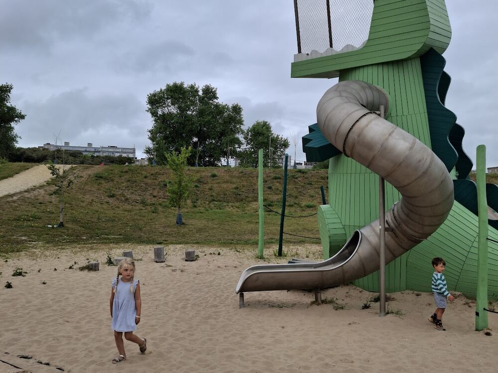 Een groene krokodilglijbaan als speeltoestel op het strand van Middelkerke